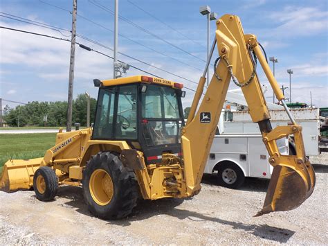 john deere 210c backhoe loader with skid steer implement mounting|jd 210c backhoe lifting capacity.